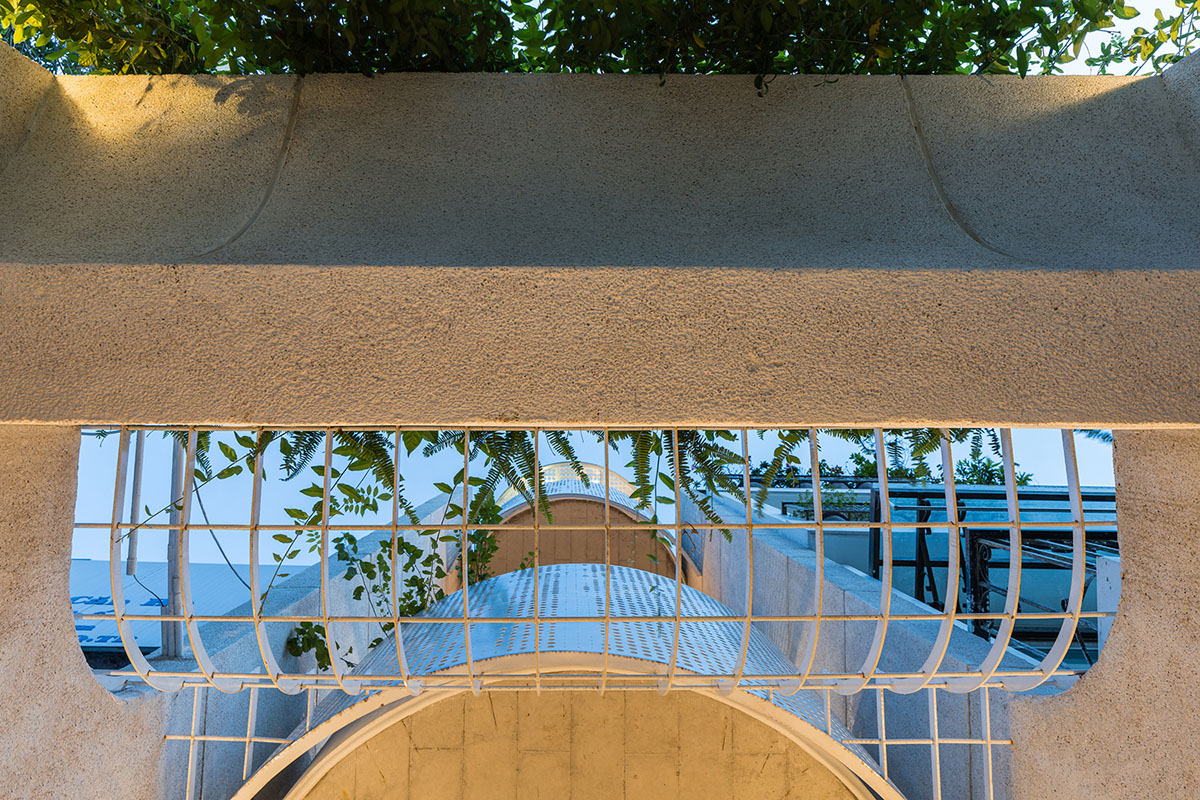 AD9 Architects built residence on a narrow plot with half-circled balconies in Vietnam