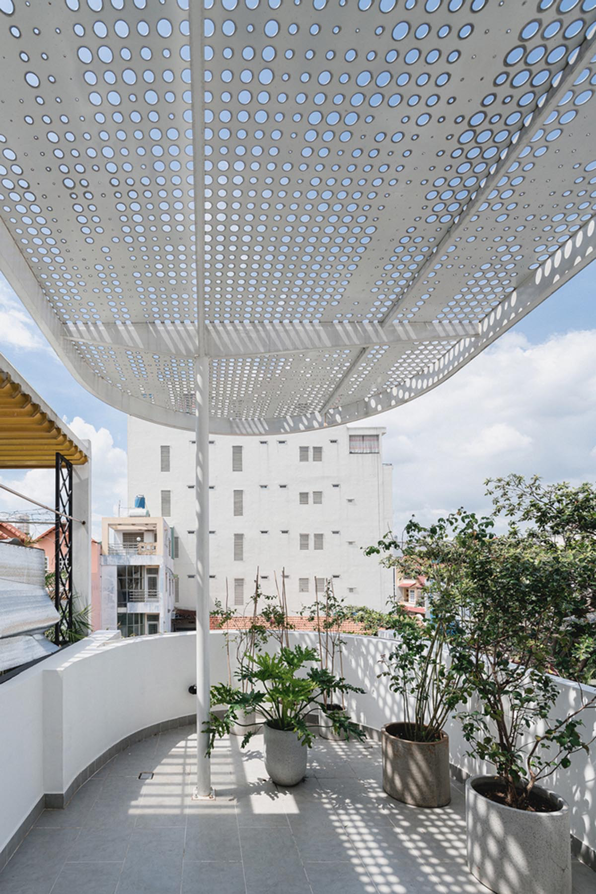 AD9 Architects built residence on a narrow plot with half-circled balconies in Vietnam