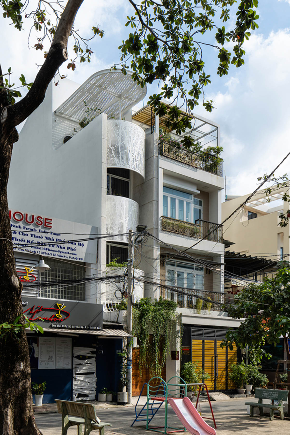 AD9 Architects built residence on a narrow plot with half-circled balconies in Vietnam