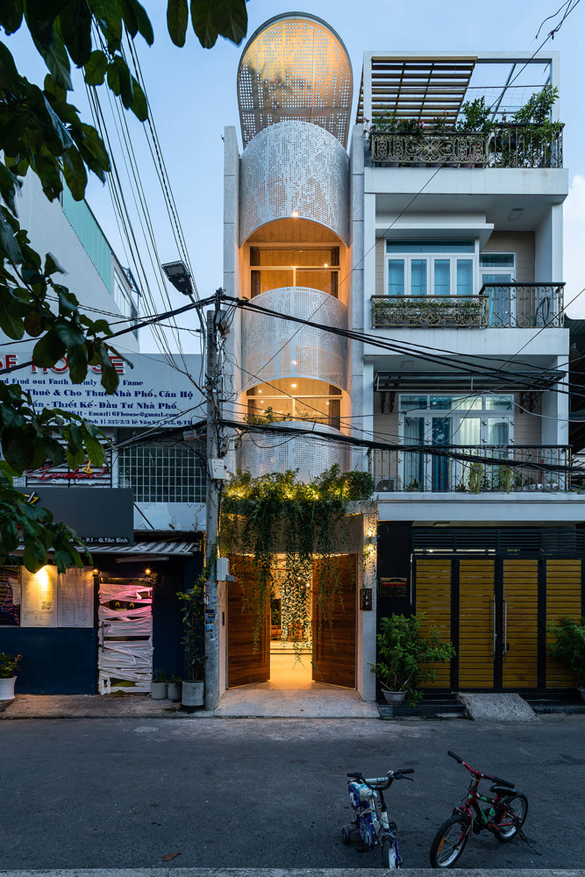 AD9 Architects built residence on a narrow plot with half-circled balconies in Vietnam