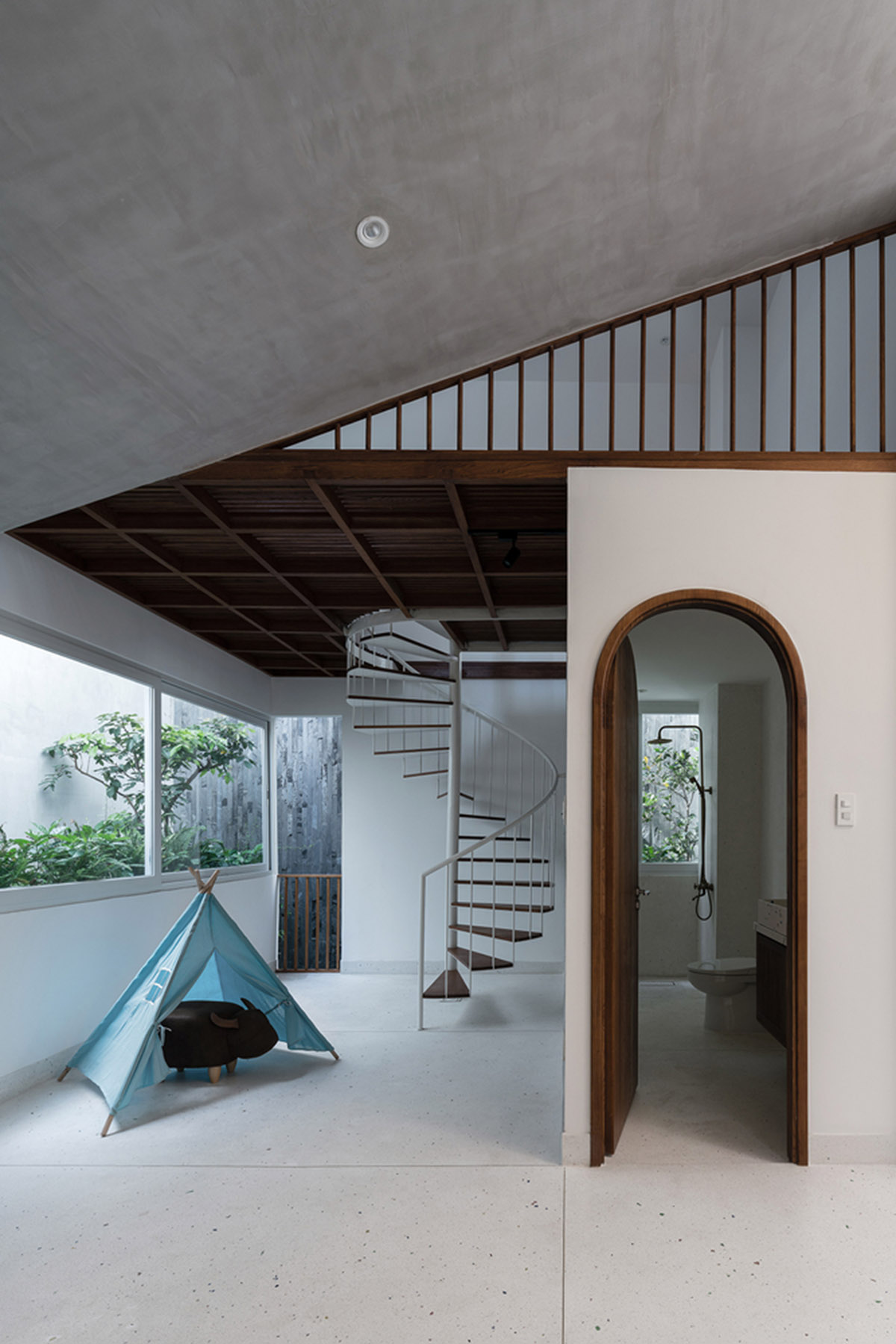 AD9 Architects built residence on a narrow plot with half-circled balconies in Vietnam