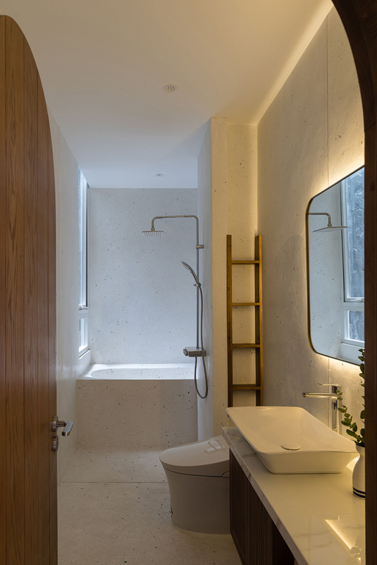 AD9 Architects built residence on a narrow plot with half-circled balconies in Vietnam