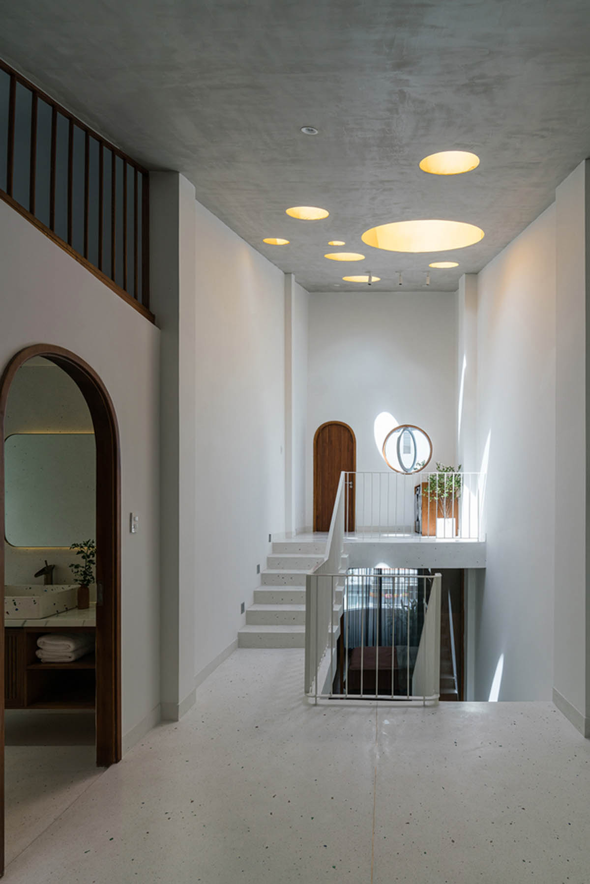 AD9 Architects built residence on a narrow plot with half-circled balconies in Vietnam