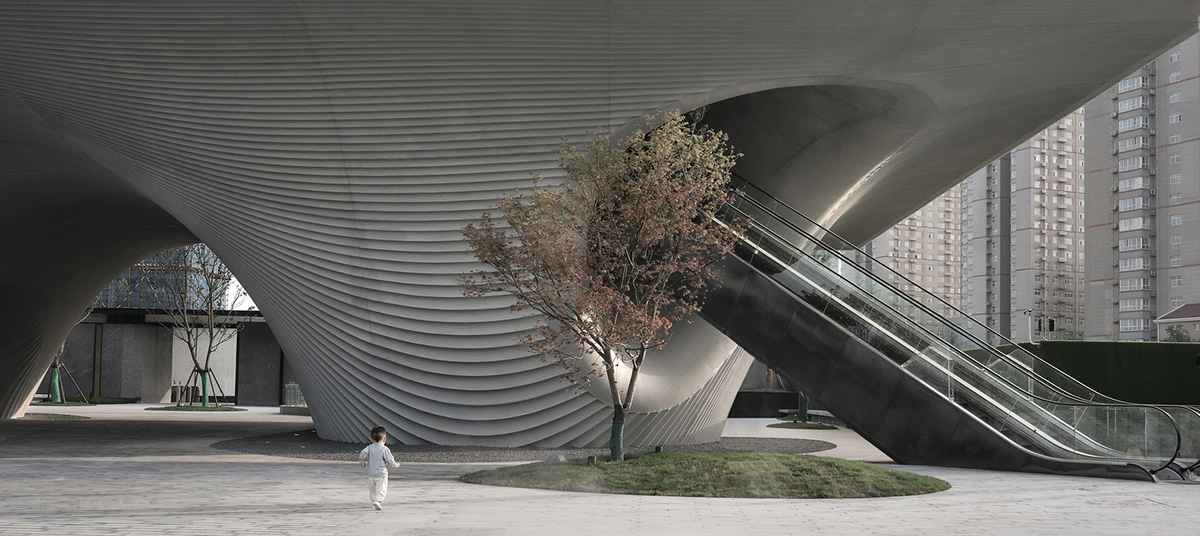 Community Center in Xi&rsquo;an is raised on sculptural base that features a rippling effect