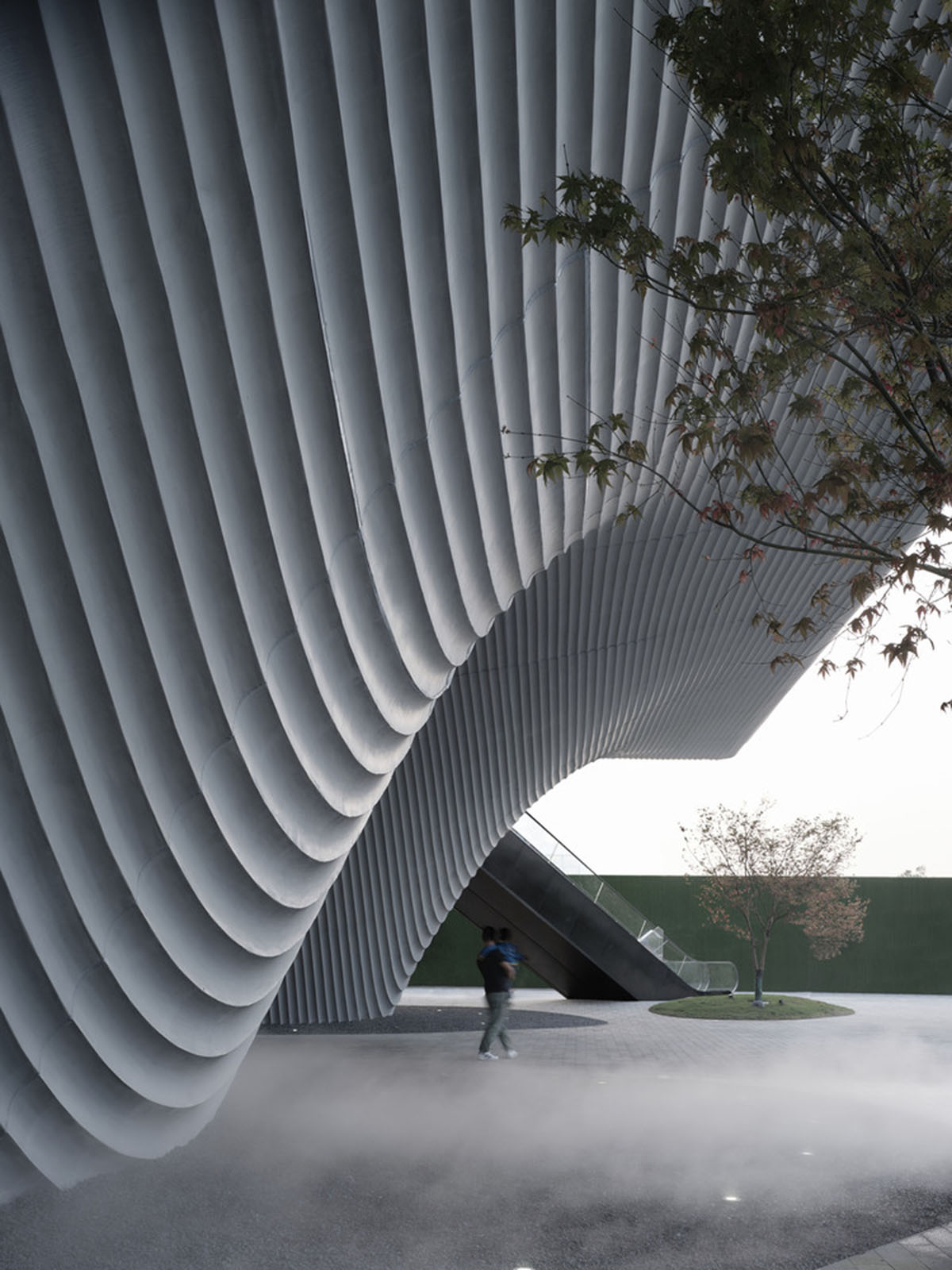 Community Center in Xi&rsquo;an is raised on sculptural base that features a rippling effect