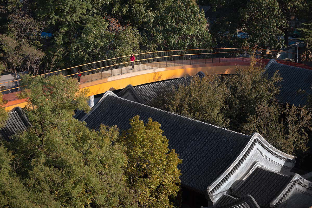MAD wraps Beijing's historic courtyard buildings with kindergarten featuring undulating red rooftop