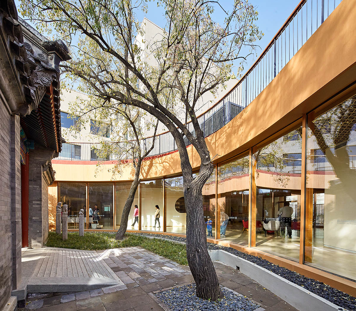MAD wraps Beijing's historic courtyard buildings with kindergarten featuring undulating red rooftop