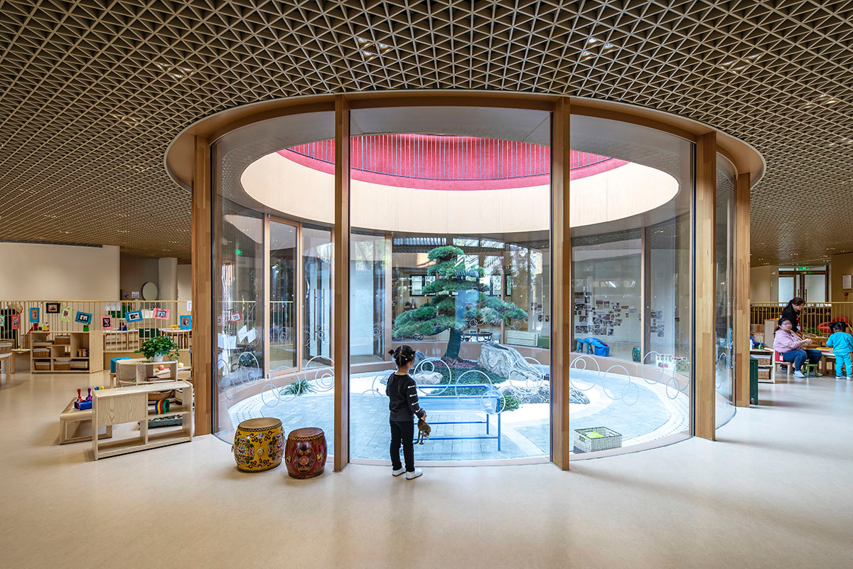 MAD wraps Beijing's historic courtyard buildings with kindergarten featuring undulating red rooftop