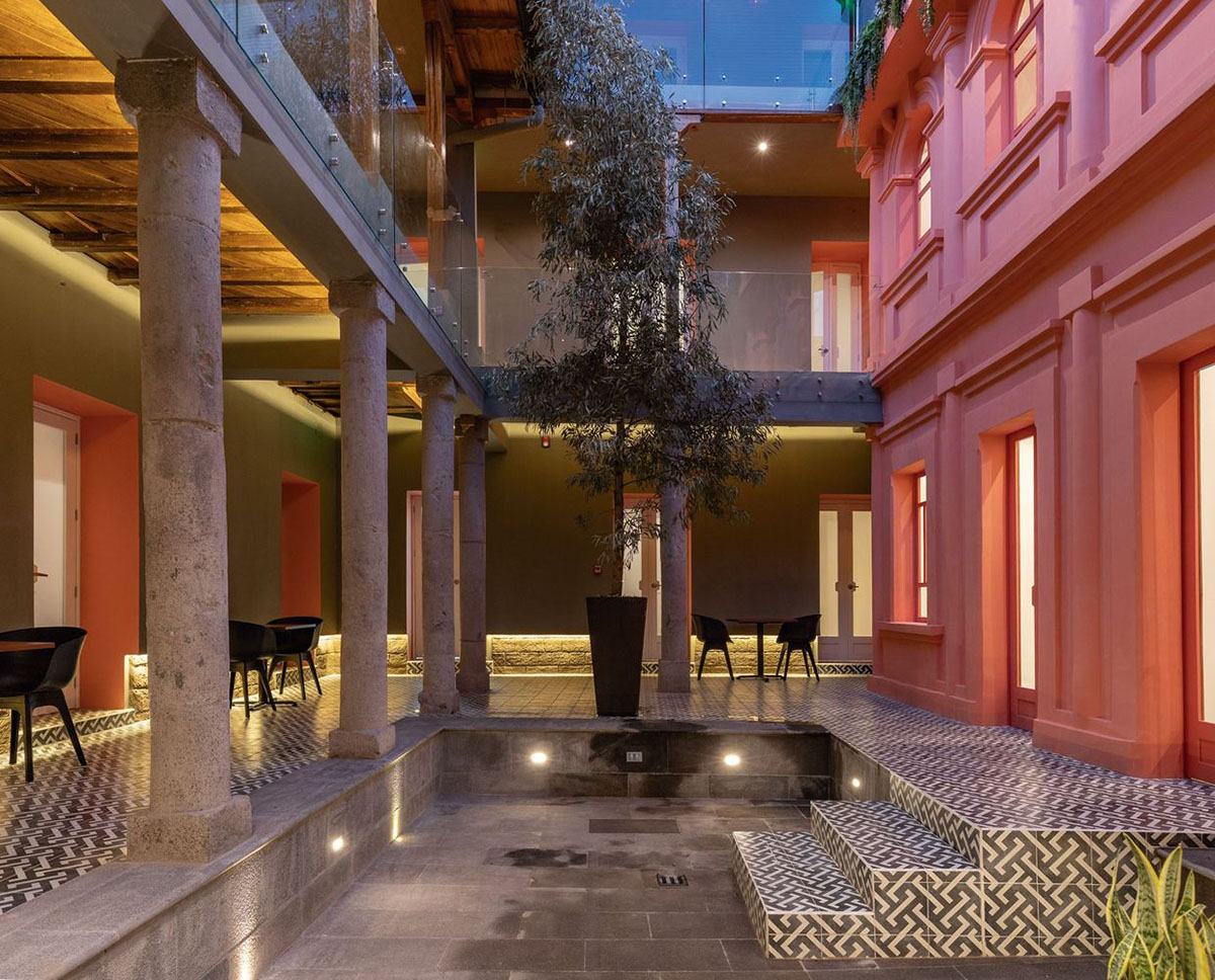 nicolas&nicolas converts old building into hotel with pinkish walls and central courtyard in Quito