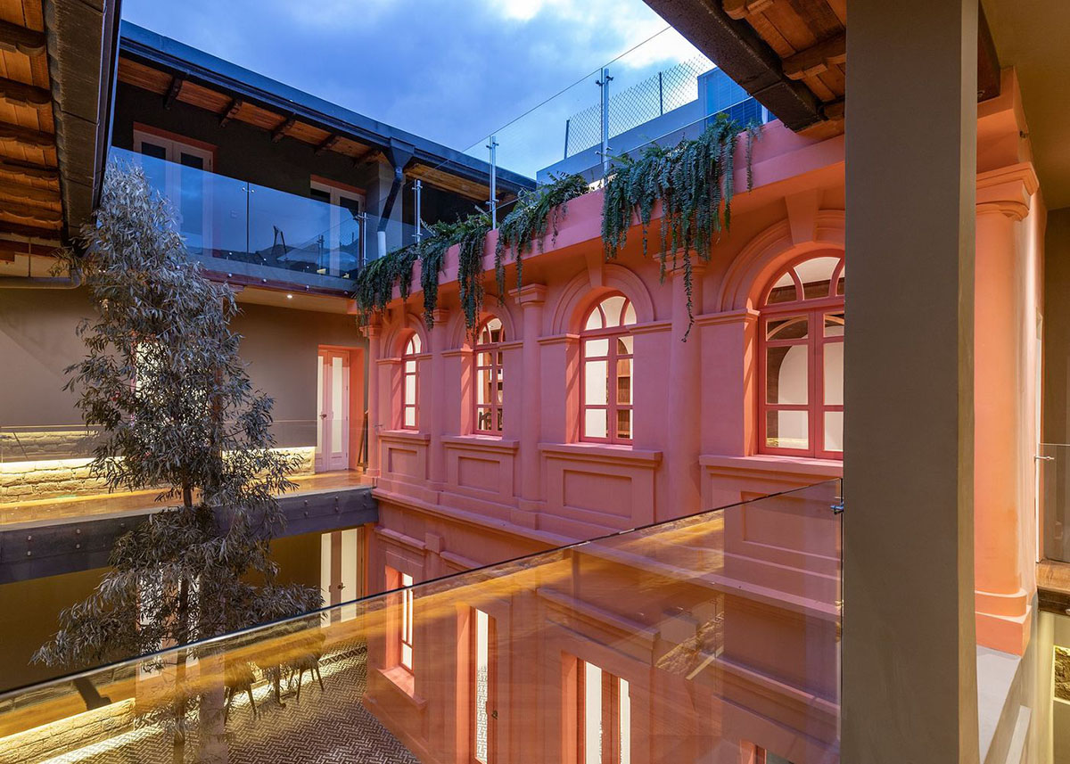 nicolas&nicolas converts old building into hotel with pinkish walls and central courtyard in Quito