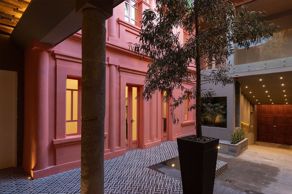 nicolas&nicolas converts old building into hotel with pinkish walls and central courtyard in Quito