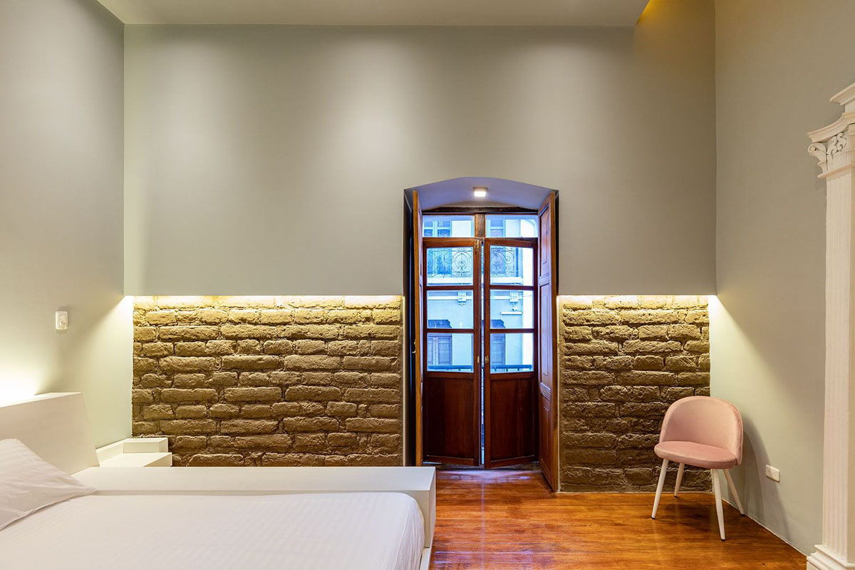 nicolas&nicolas converts old building into hotel with pinkish walls and central courtyard in Quito