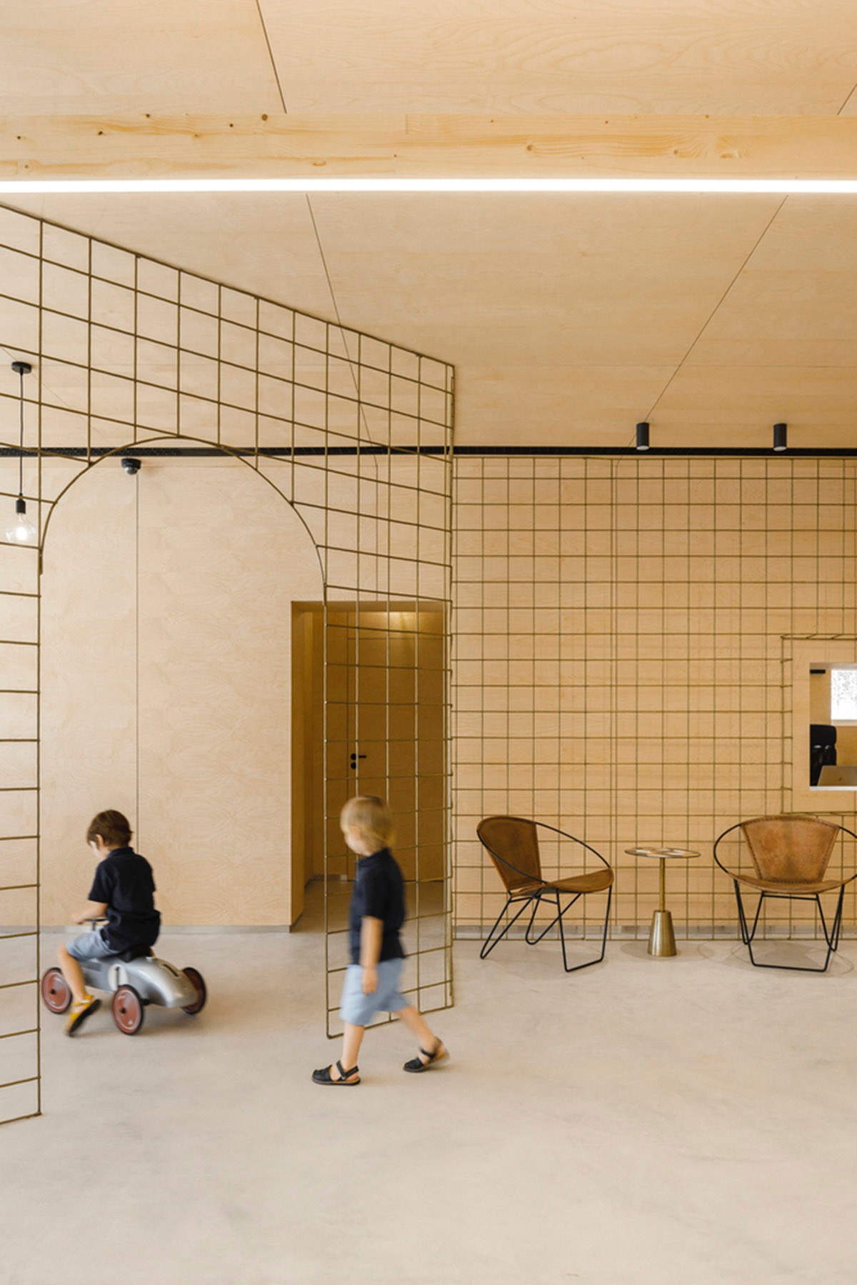 stu.dere divides interior space with golden wire meshes for multiple uses in this store in Portugal
