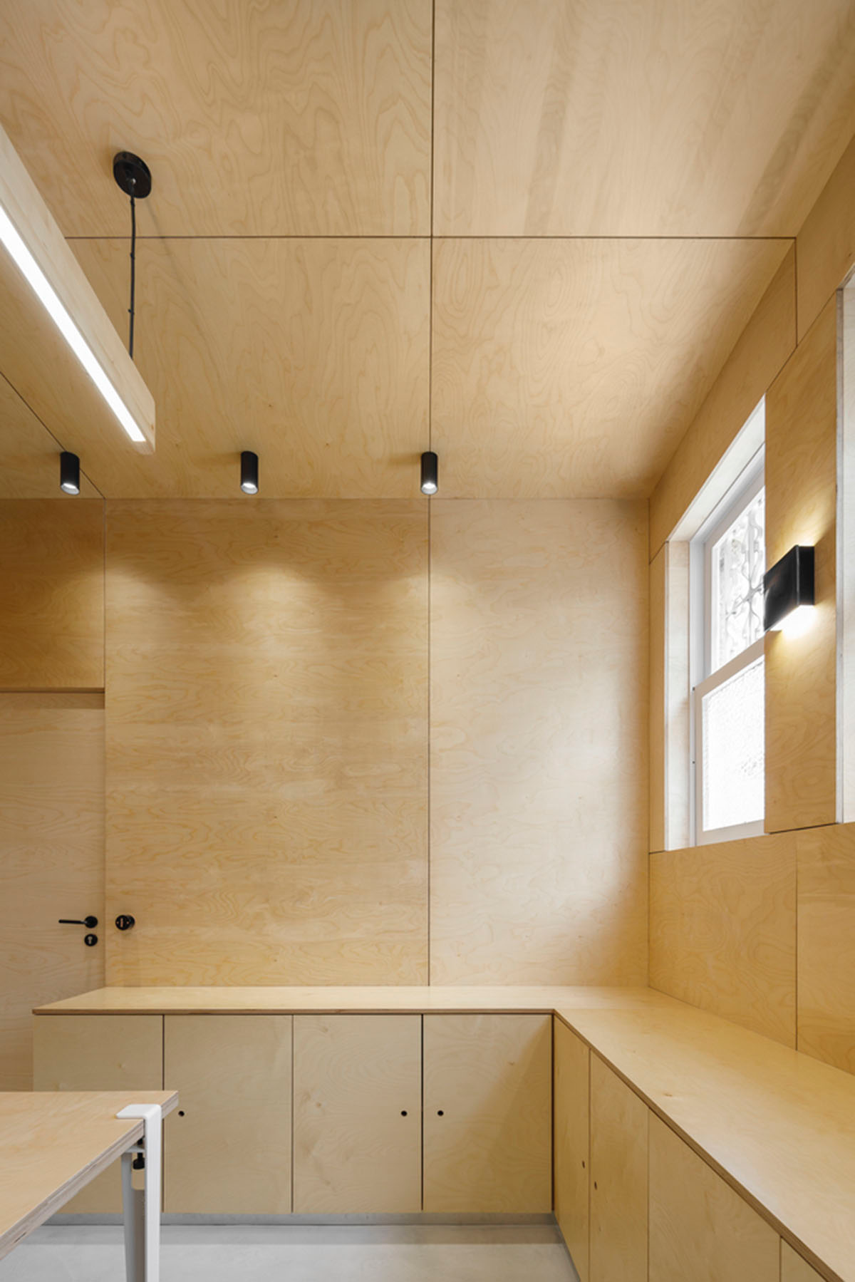 stu.dere divides interior space with golden wire meshes for multiple uses in this store in Portugal