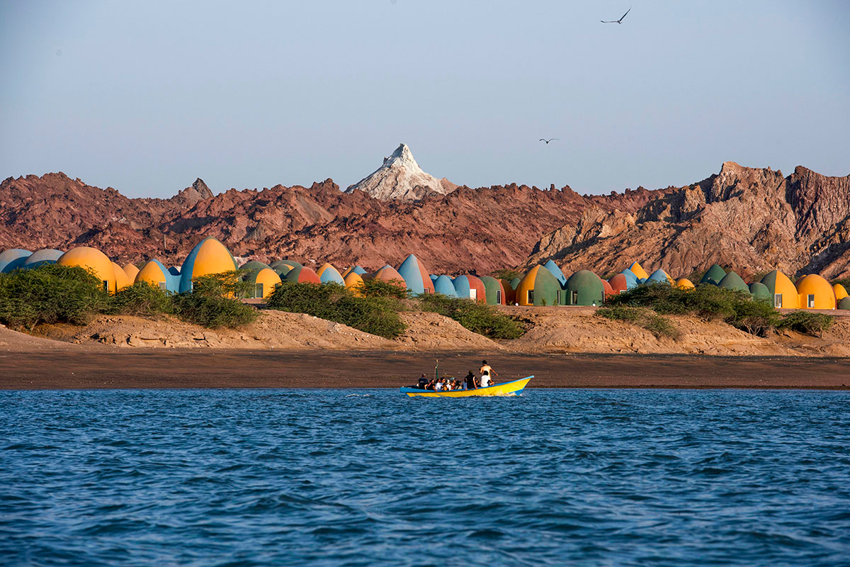 ZAV Architects built colorful-domed housing made of rammed earth and sand on Hormuz island, Iran