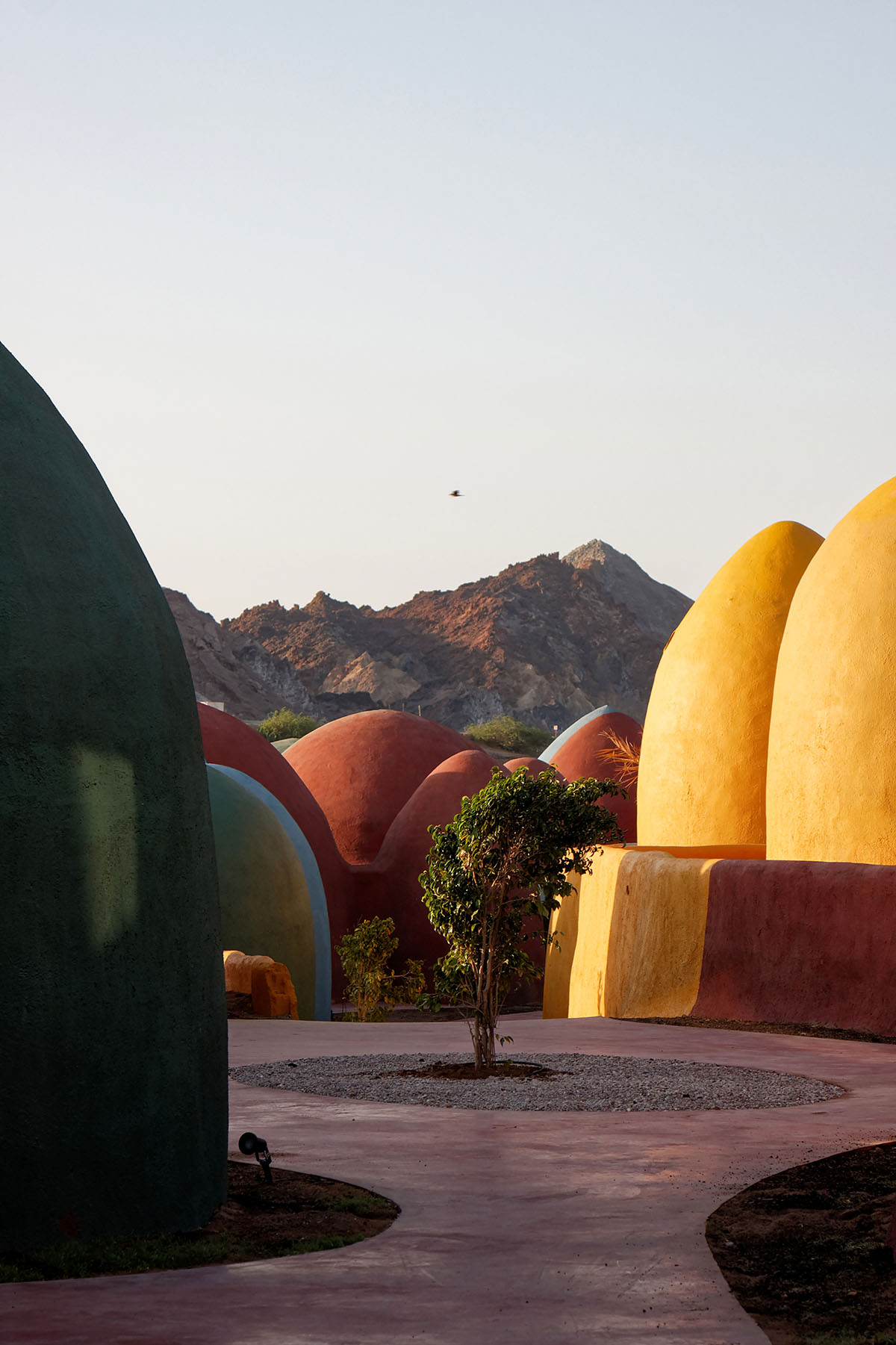 ZAV Architects built colorful-domed housing made of rammed earth and sand on Hormuz island, Iran