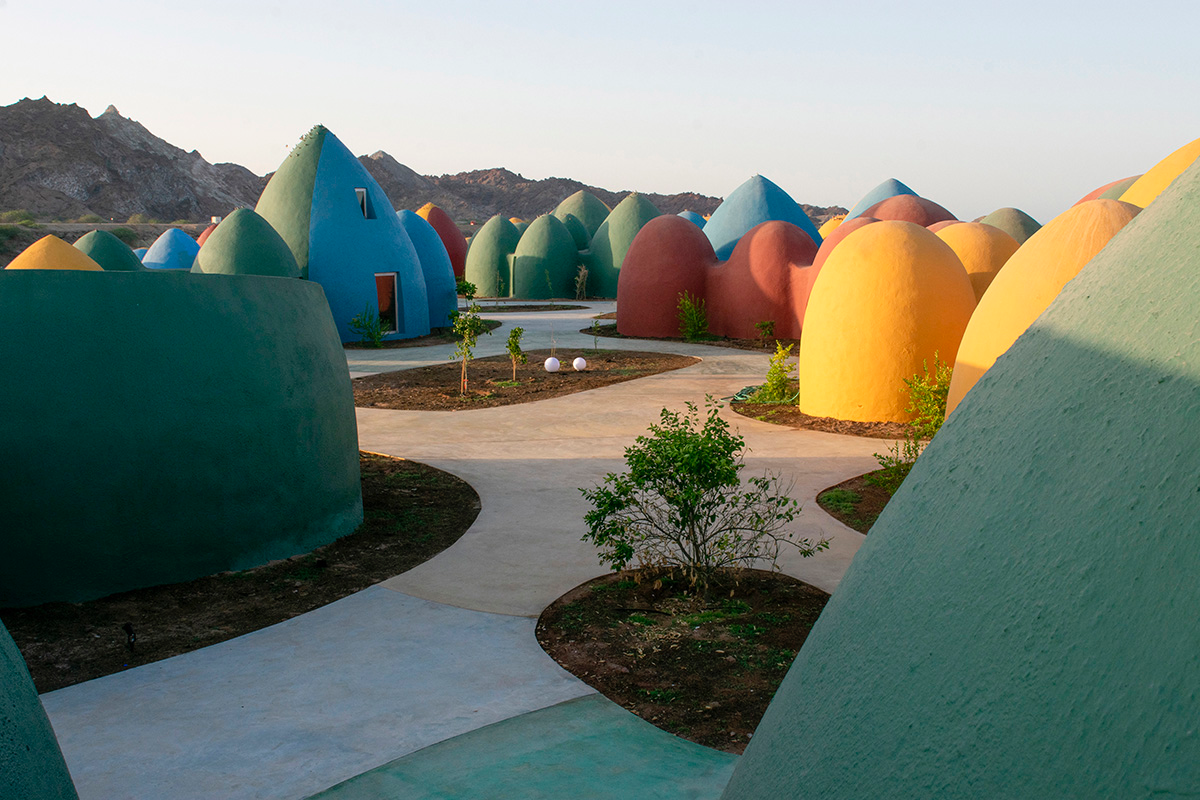 ZAV Architects built colorful-domed housing made of rammed earth and sand on Hormuz island, Iran