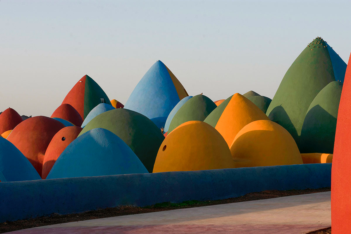 ZAV Architects built colorful-domed housing made of rammed earth and sand on Hormuz island, Iran