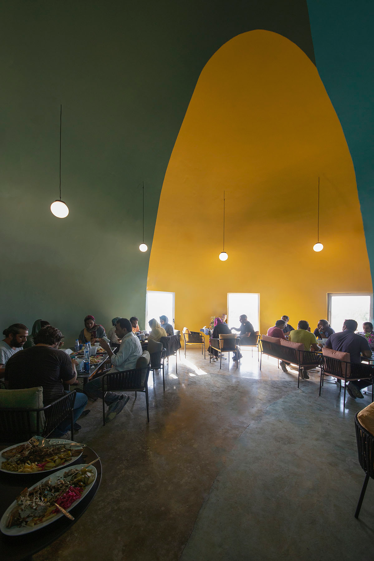 ZAV Architects built colorful-domed housing made of rammed earth and sand on Hormuz island, Iran
