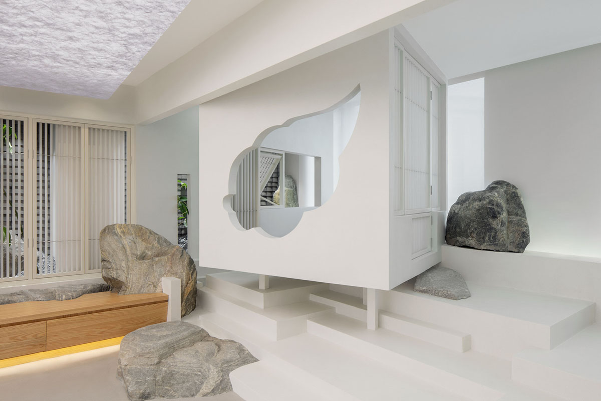 Jiejie studio wraps this tea room with a peach garden with rocky and forest landscape in Beijing