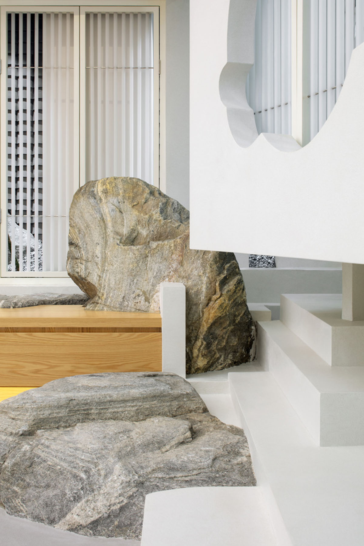 Jiejie studio wraps this tea room with a peach garden with rocky and forest landscape in Beijing