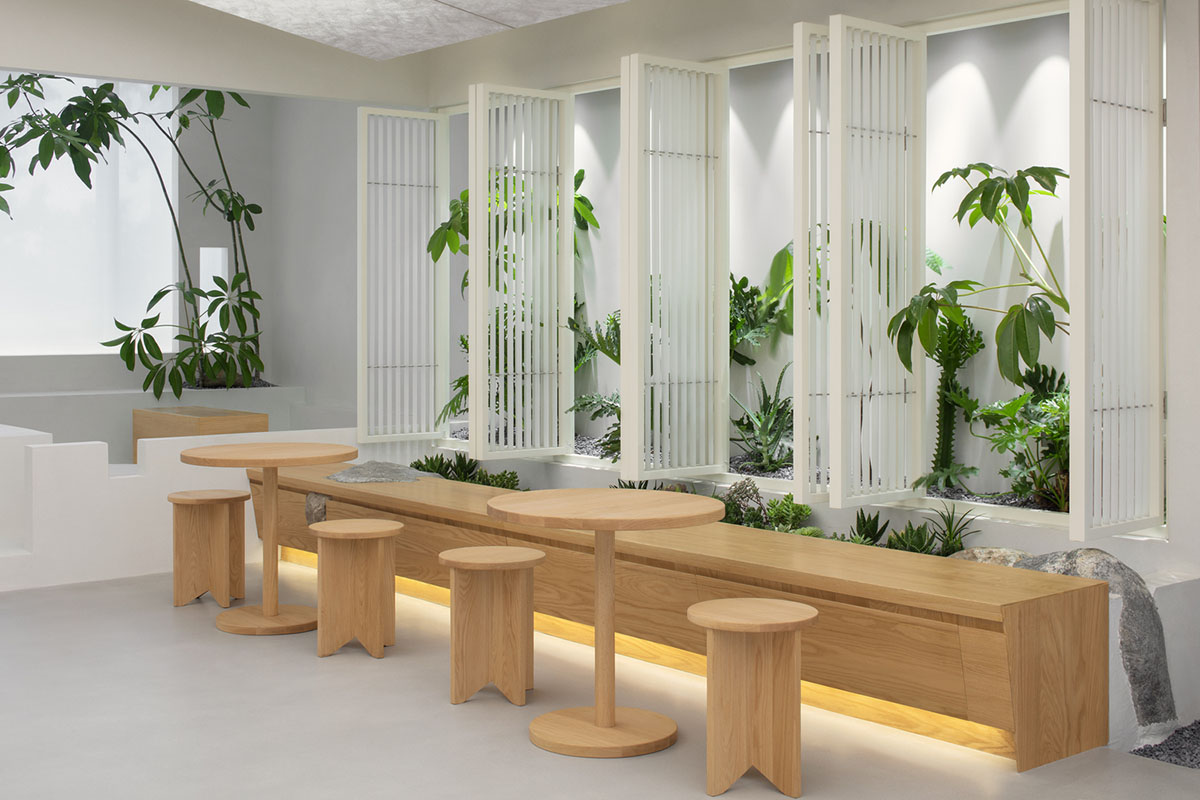 Jiejie studio wraps this tea room with a peach garden with rocky and forest landscape in Beijing