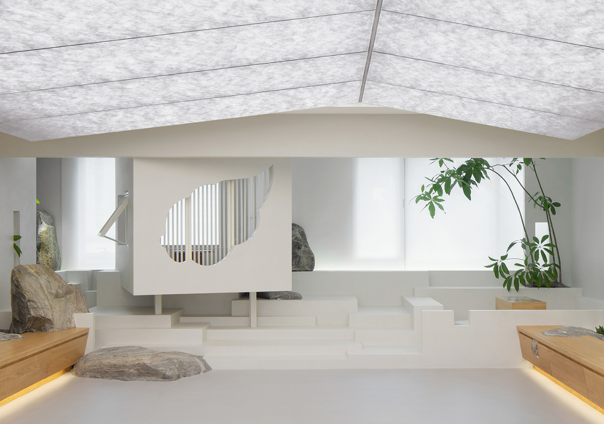 Jiejie studio wraps this tea room with a peach garden with rocky and forest landscape in Beijing