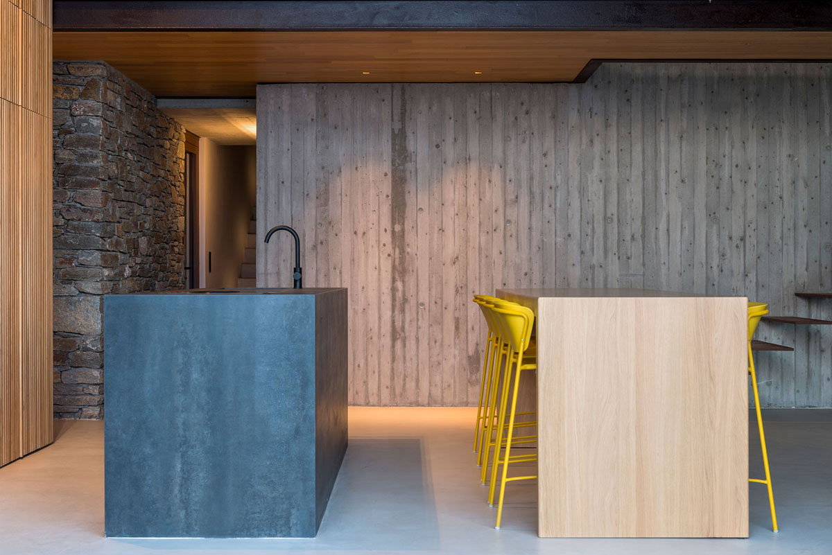 MOLD Architects used advantages of sloping land to design Ncaved house in Greece