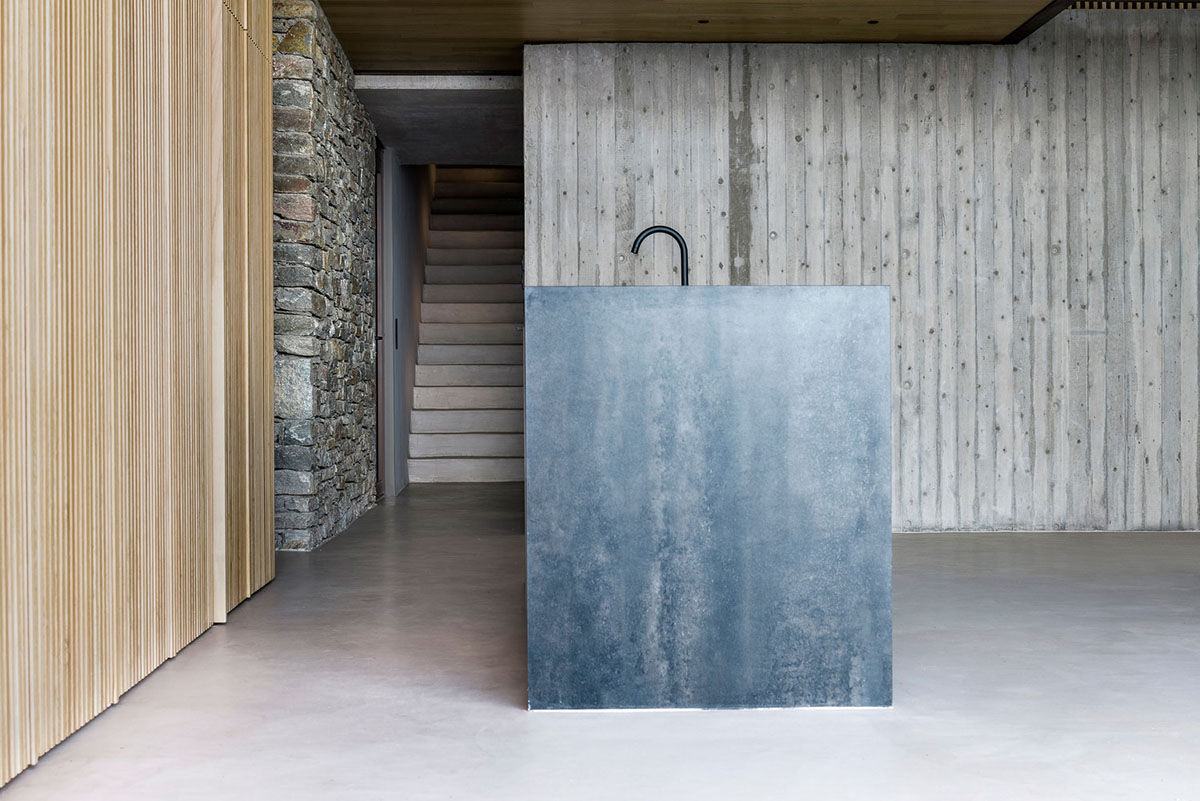 MOLD Architects used advantages of sloping land to design Ncaved house in Greece