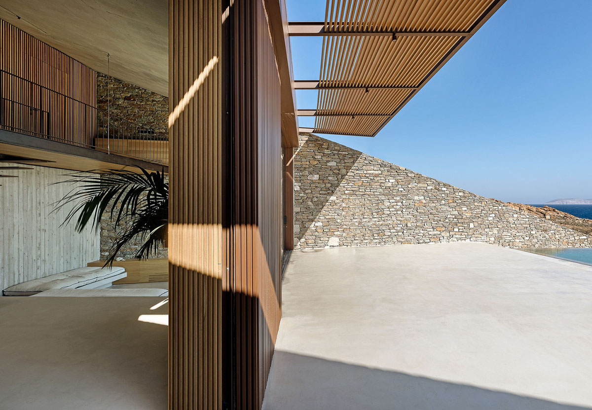 MOLD Architects used advantages of sloping land to design Ncaved house in Greece