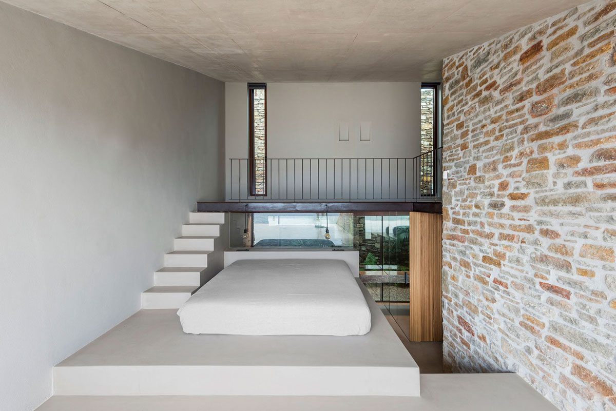 MOLD Architects used advantages of sloping land to design Ncaved house in Greece