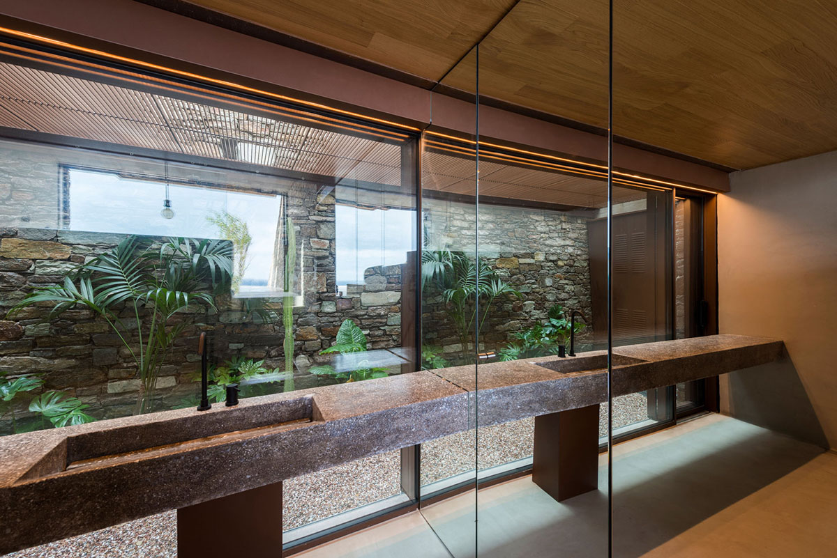 MOLD Architects used advantages of sloping land to design Ncaved house in Greece