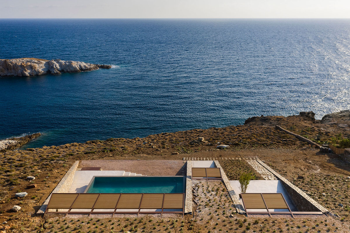 MOLD Architects used advantages of sloping land to design Ncaved house in Greece