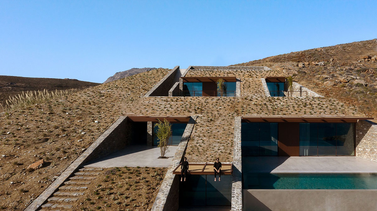 MOLD Architects used advantages of sloping land to design Ncaved house in Greece