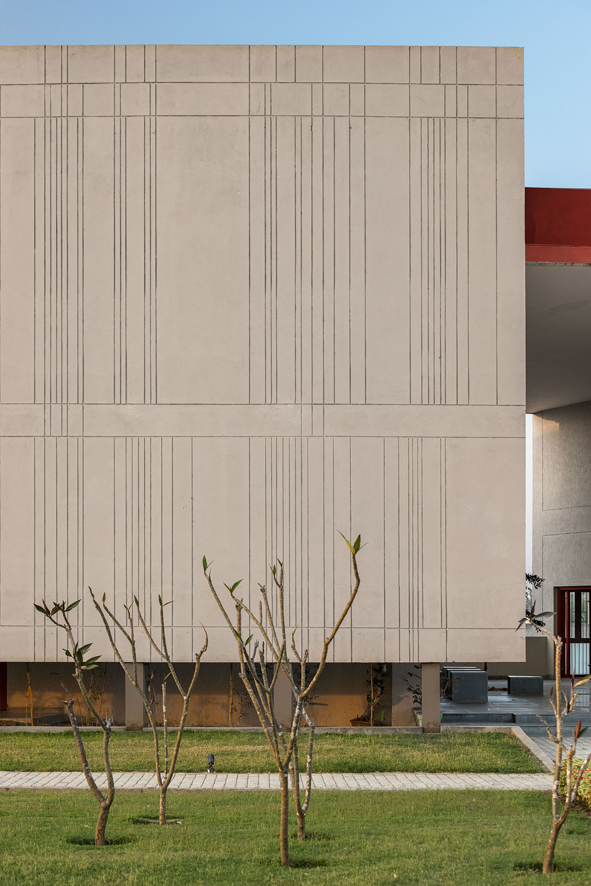 Kamat & Rozario Architecture built school with fortress-like blank walls and colored bridges