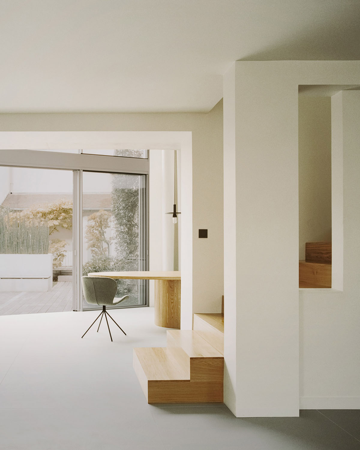 White concrete curved bridge gently complements interiors of The Island House in Paris