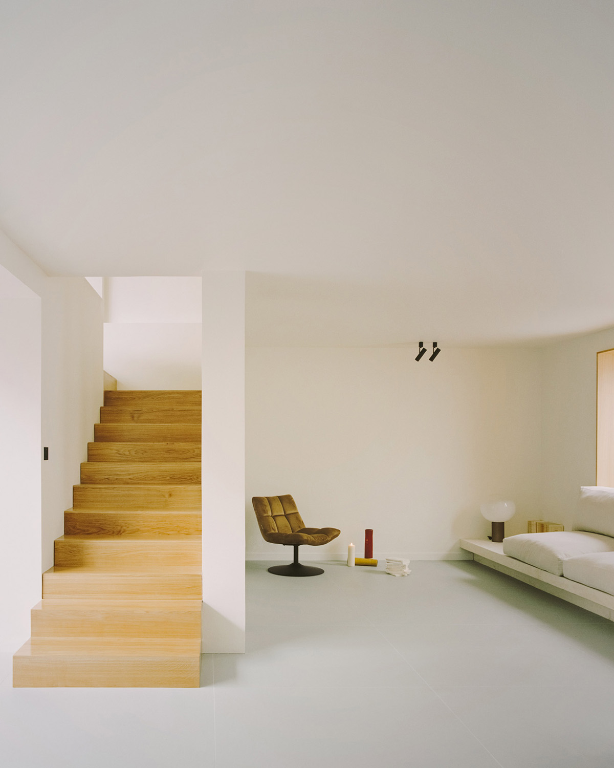 White concrete curved bridge gently complements interiors of The Island House in Paris