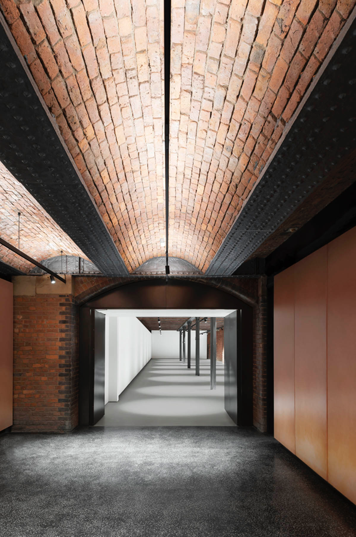 Carmody Groarke completes gallery that features brick vaulted ceilings and back-lit panels