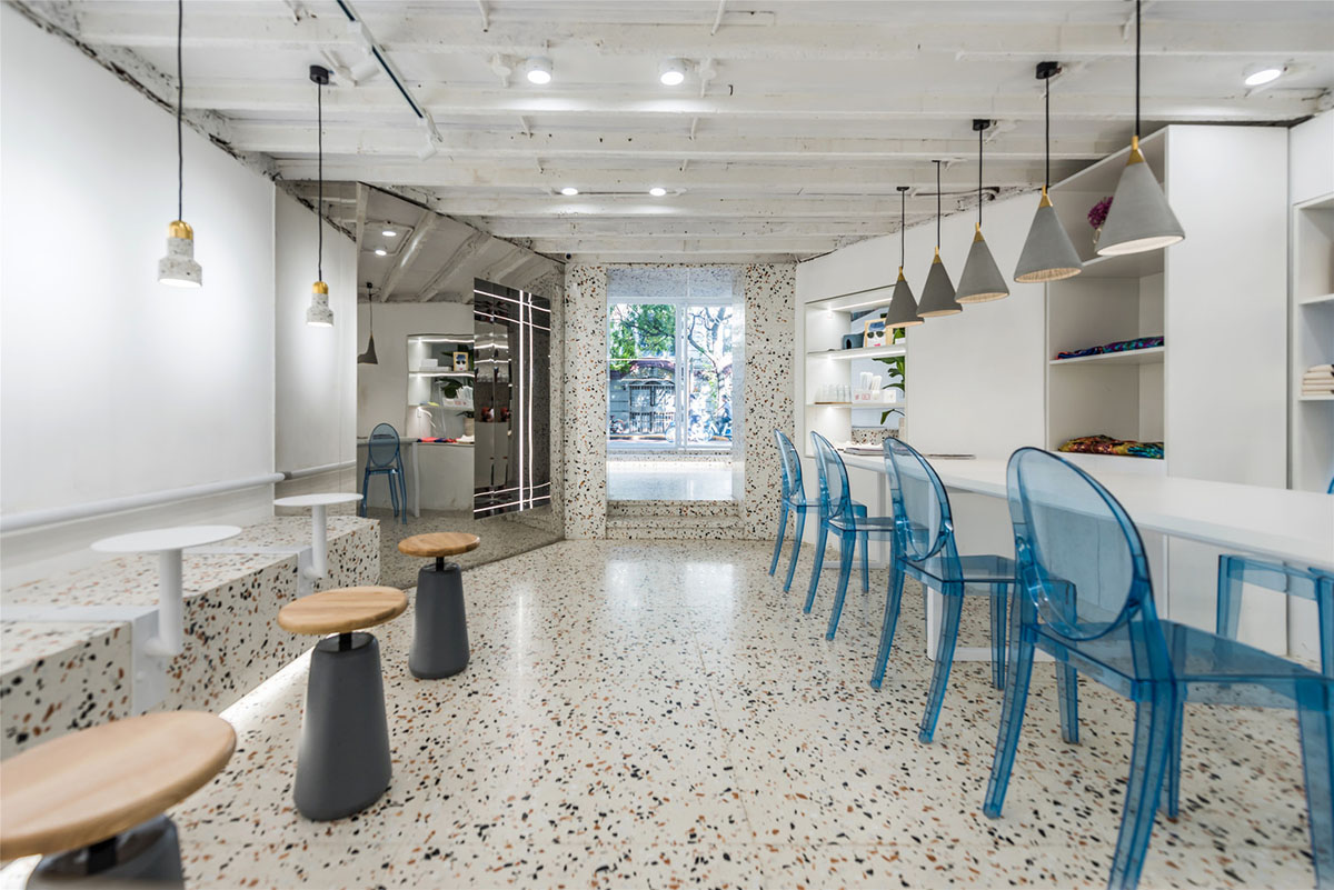 This tiny cafe by TOUCH Design is dotted with white and orange interwoven terrazzo details in Tianjin