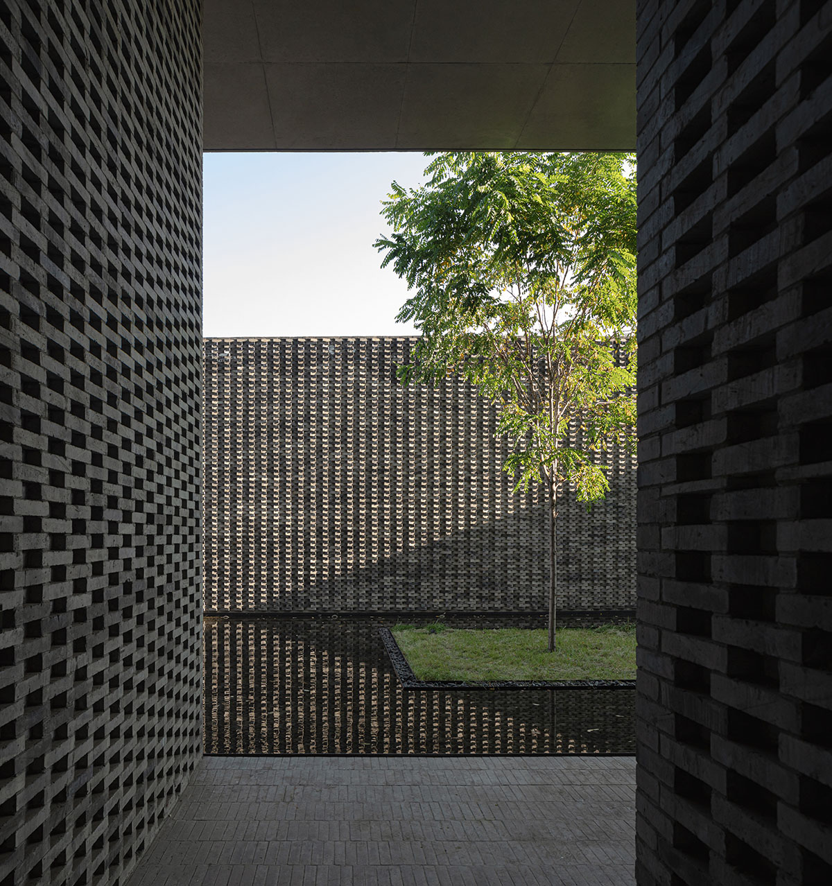 Grey brick walls wrap a factory building referencing to local construction methods in China 
