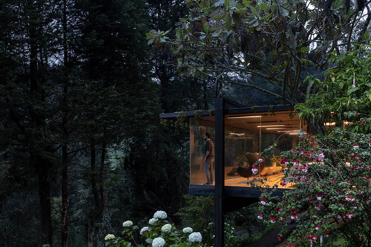 RAMA estudio built glazed retreat that sits on slope with minimal touch overlooking valley in Ecuador