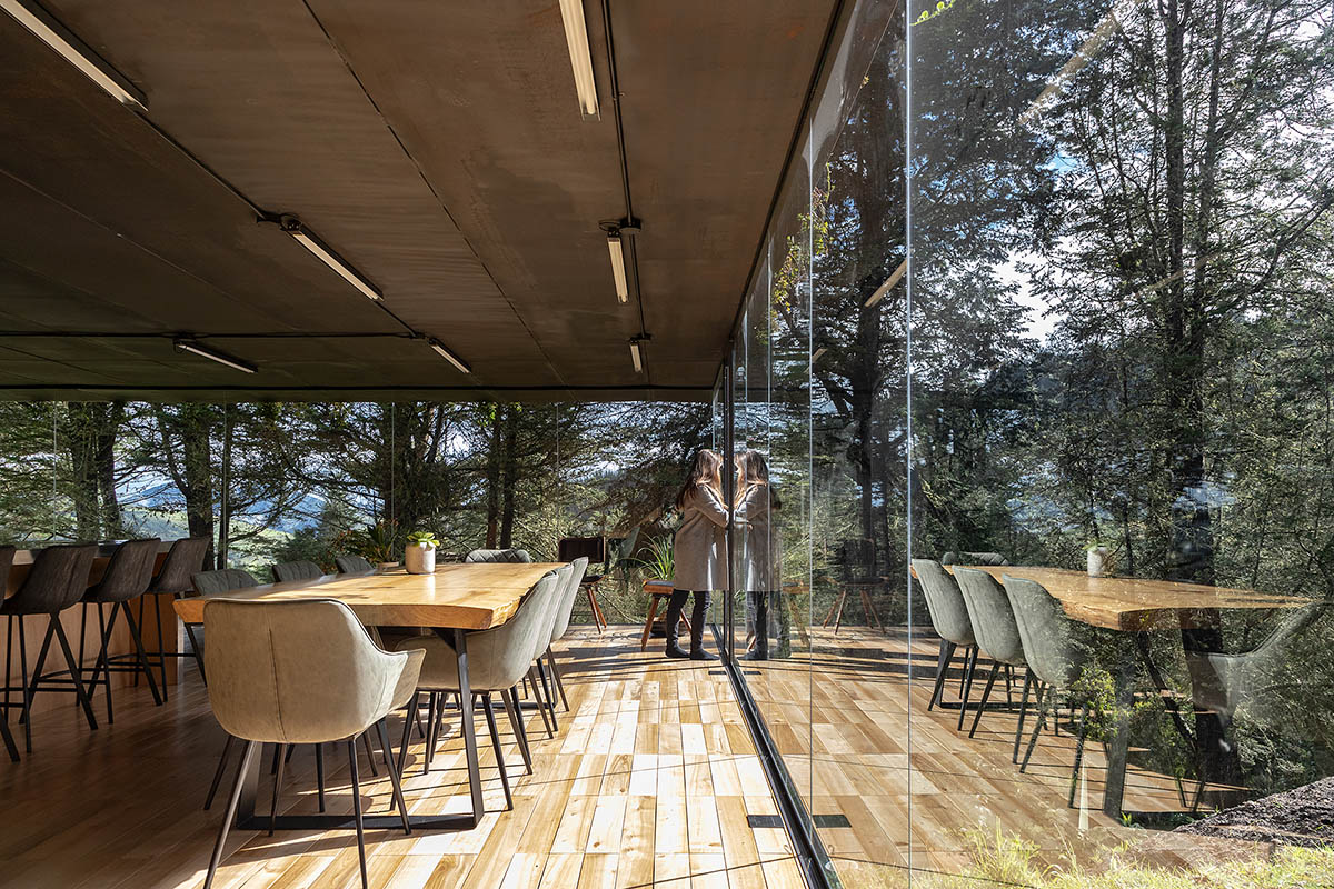 RAMA estudio built glazed retreat that sits on slope with minimal touch overlooking valley in Ecuador