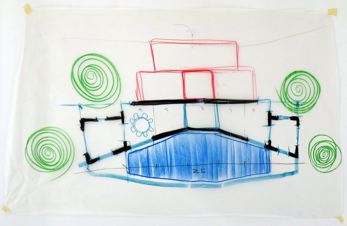 Castle-like red-pigmented house features recessed volumes on arid landscape of Alentejo