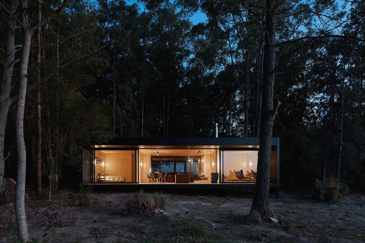 Black wooden cabin by iHouse estudio is an off-grid escape home in Uruguayan native forest