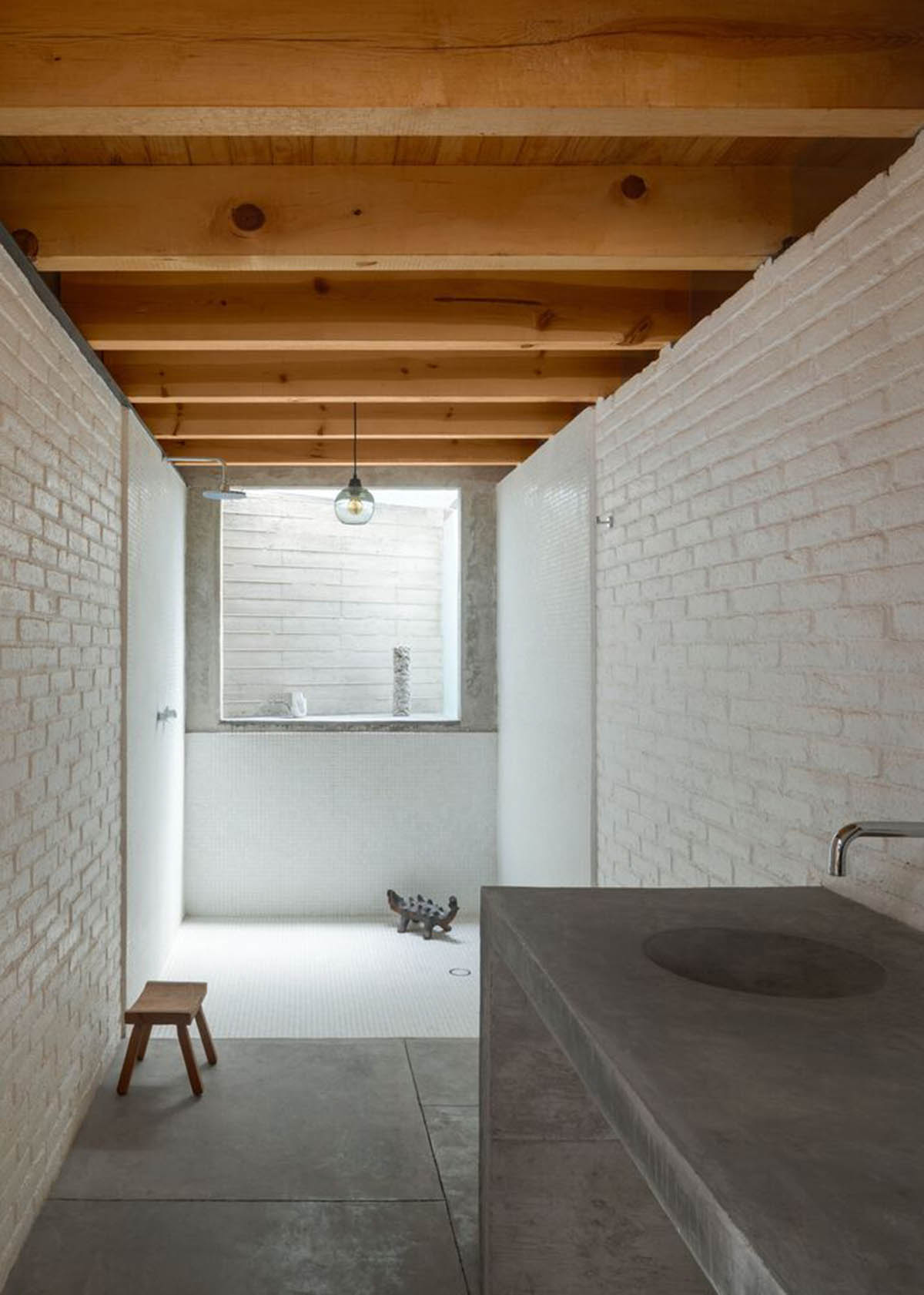 Sculptor's home studio features industrial saw-tooth roofs creating breathing interiors in Mexico