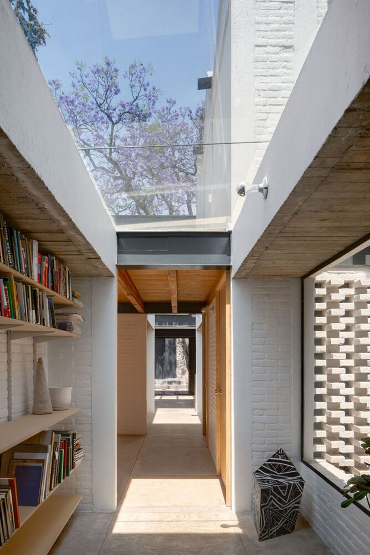 Sculptor's home studio features industrial saw-tooth roofs creating breathing interiors in Mexico