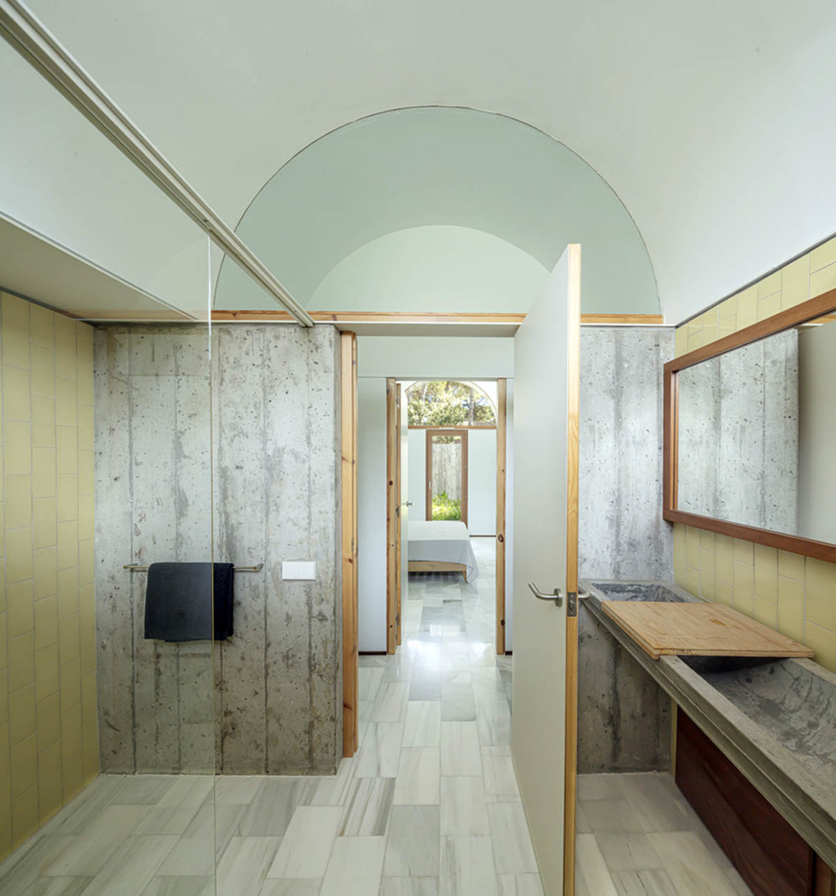 Summer house by BELLAFILARQUITECTES features semicircular vaults clad in green tiles in Spain