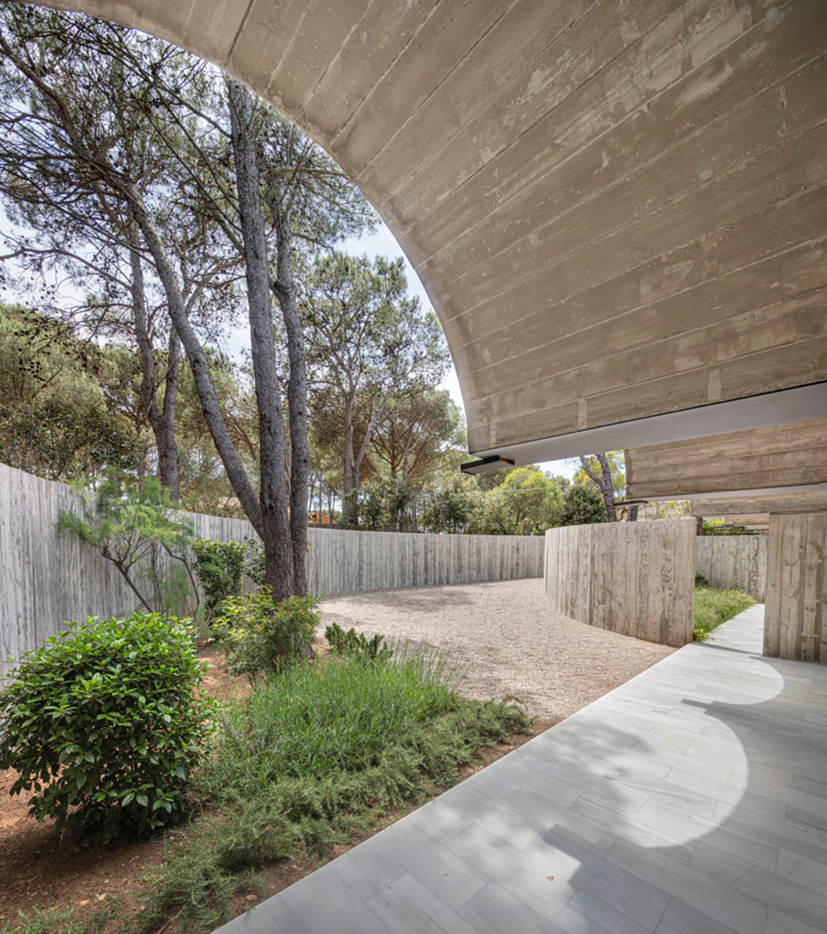 Summer house by BELLAFILARQUITECTES features semicircular vaults clad in green tiles in Spain
