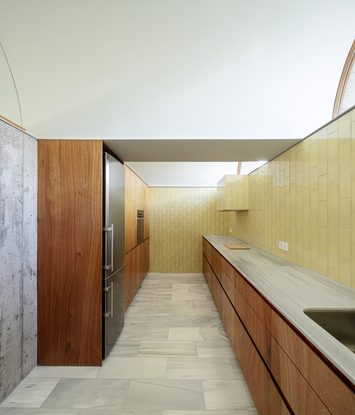 Summer house by BELLAFILARQUITECTES features semicircular vaults clad in green tiles in Spain