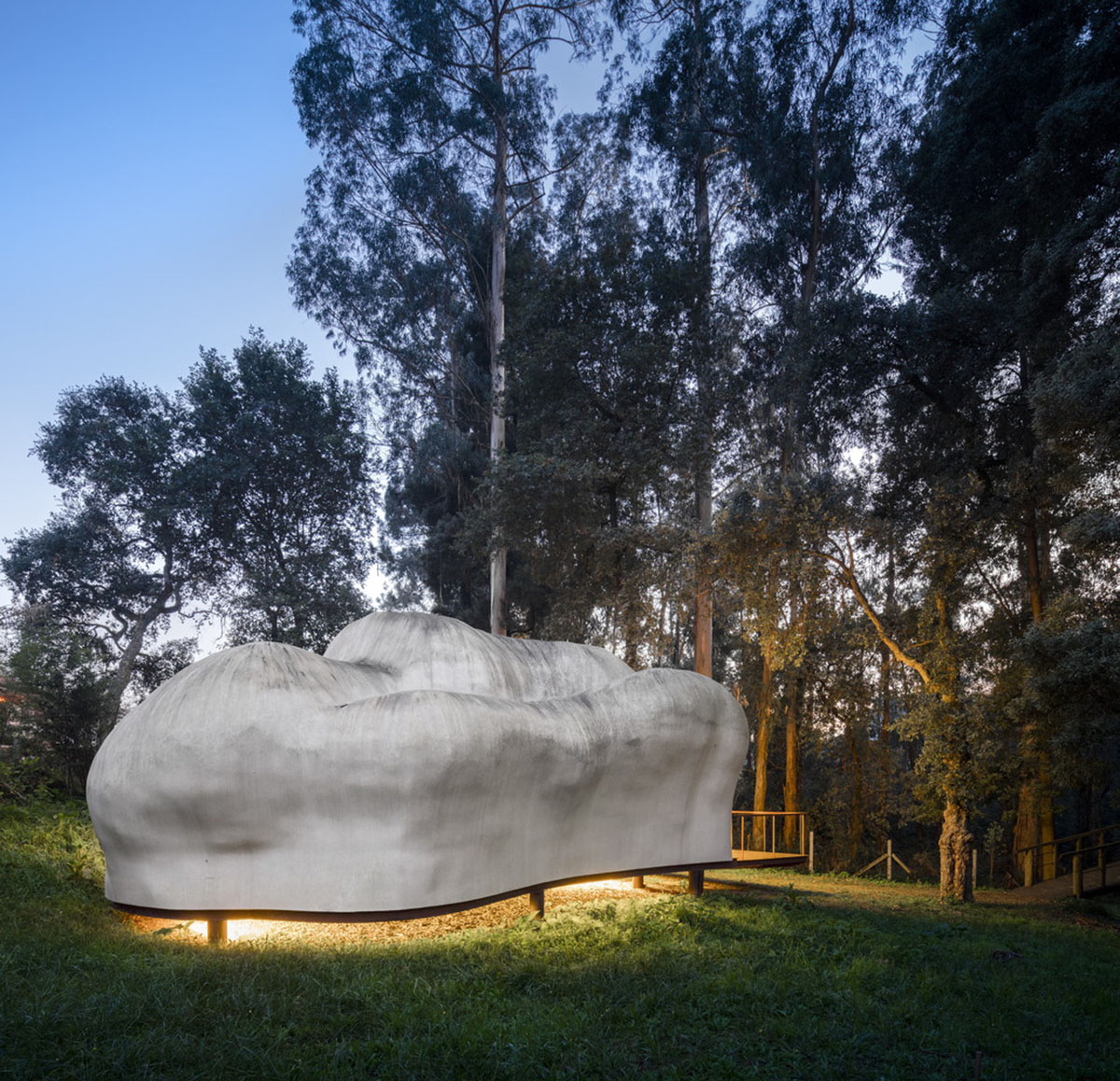 Super small cave-like art gallery by FCC Arquitectura built on lush green in Portugal